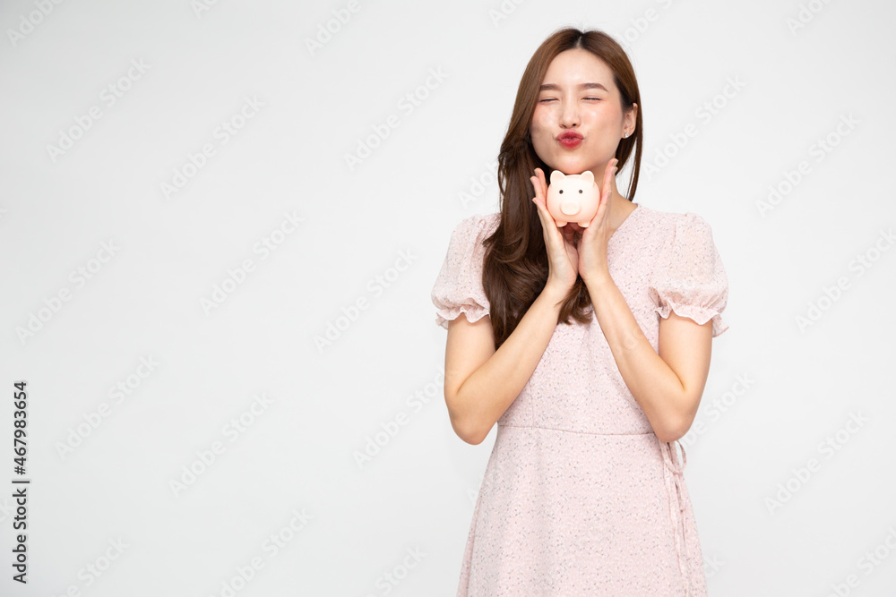 Portrait of Asian woman holding piggy bank isolated on white background, Business and financial concept Portrait of Asian woman holding piggy bank isolated on white background, Business and financial concept