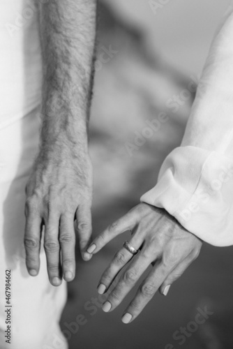 the bride and groom tenderly hold hands between them love