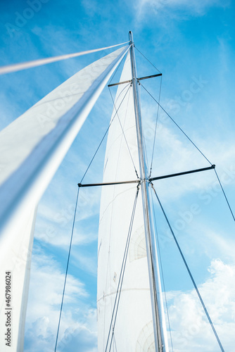 high mast with a white sail