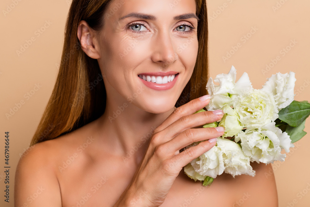 Cropped photo of optimistic mature brunette lady with roses nude isolated over beige color background