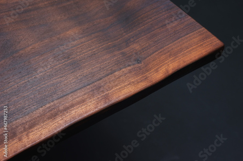 Style wooden countertop slab, saw cut wood treated with varnish close-up on black. Isolate.