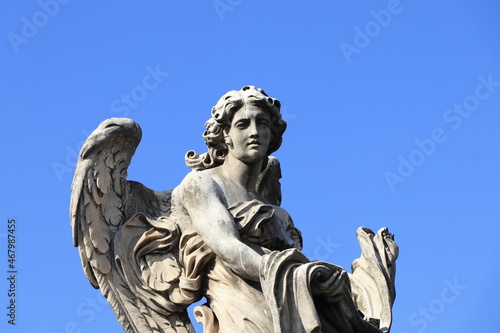 Angel with the Garment and Dice Statue on the Ponte Sant'Angelo Bridge Close Up in Rome, Italy