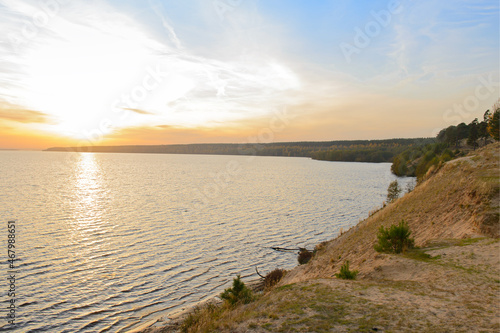 Autumn landscape with a sandy riverbank at sunset