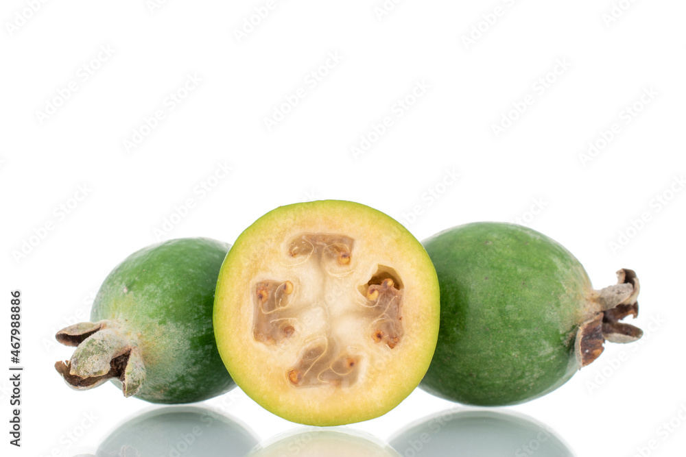 Two whole and one half organic sweet feijoa fruit, close-up, isolated on white. Two whole and one half organic sweet feijoa fruit, close-up, isolated on white.