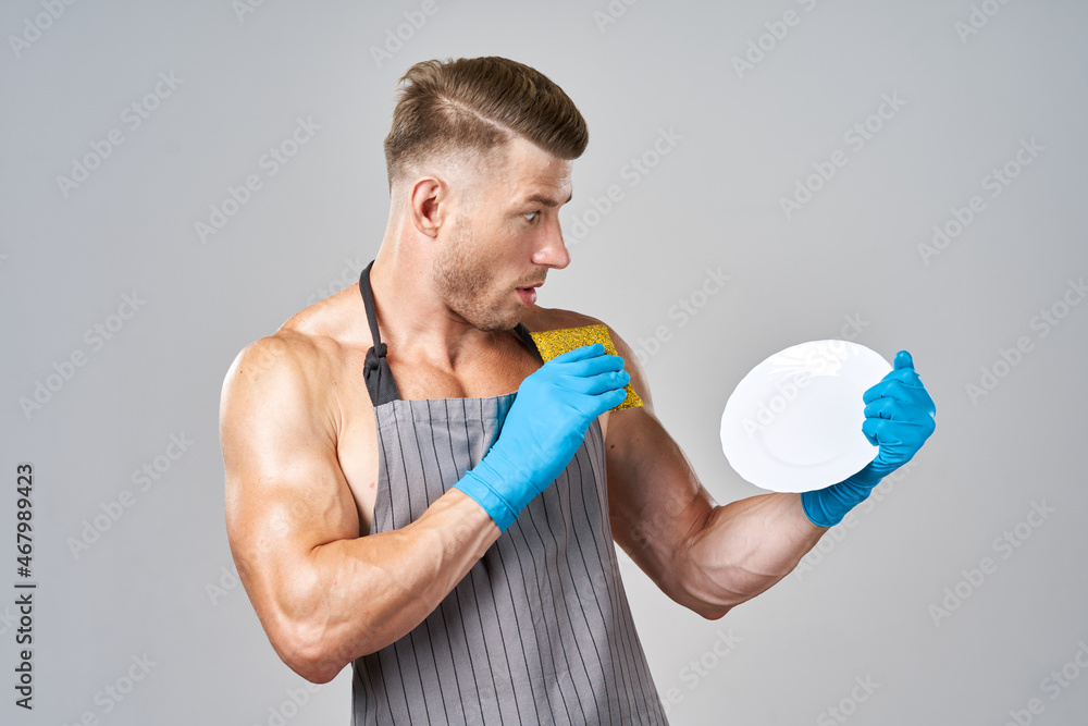 a man in an apron washing dishes cleaning service a man in an apron washing dishes cleaning service