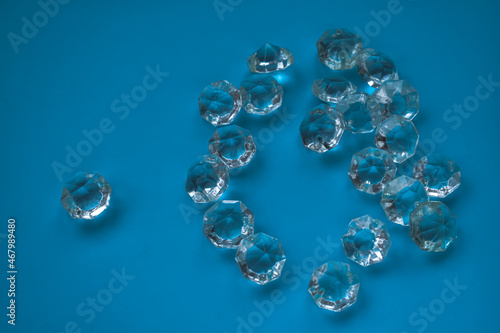 The heart is lined with transparent beads. Background of transparent crystals. Flat picture. Photographed from above. selective focus