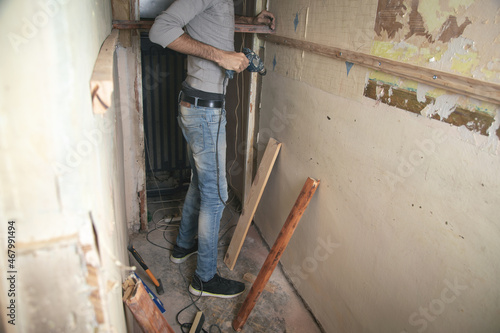 Man holds a drill. Doing home renovation