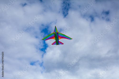 Photo of an airplane that flies in the blue sky with white clouds and gray clouds