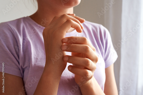 Teenager practicing EFT - emotional freedom technique - tapping on the karate chop point photo