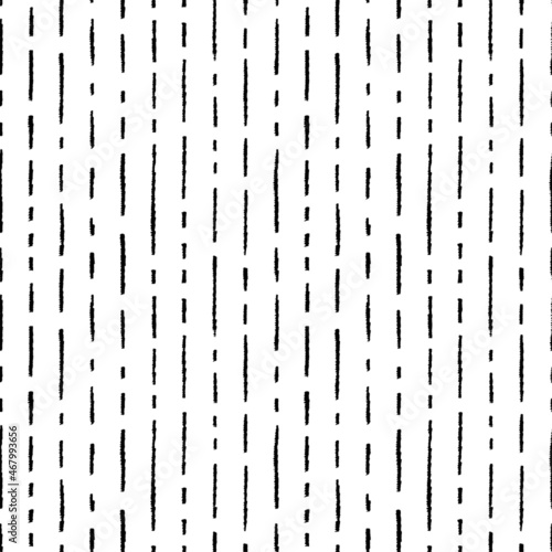 Short vertical lines vector seamless pattern. Hand drawn short brush stroke texture. Black paint grunge dashes. Abstract geometric pattern with black interrupted dotted lines. Vector different dashes.