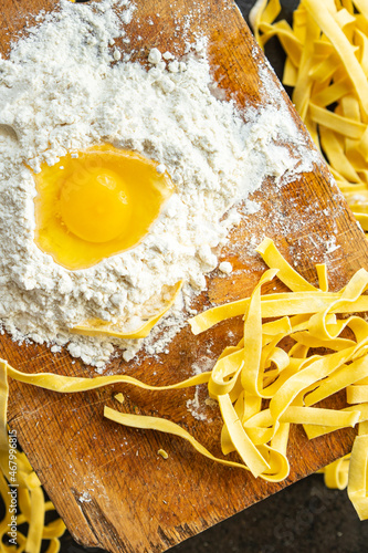 Obraz na plátně egg pasta raw tagliatelle handmade cooking durum wheat meal on the table copy sp