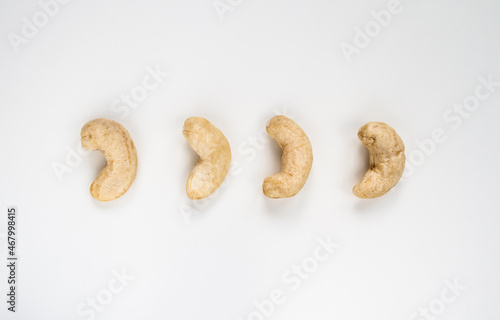 Cashew kidney-shaped nuts on a white background.