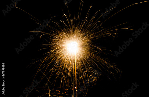 New Year s Eve celebration with a sparkler  isolated on black background.