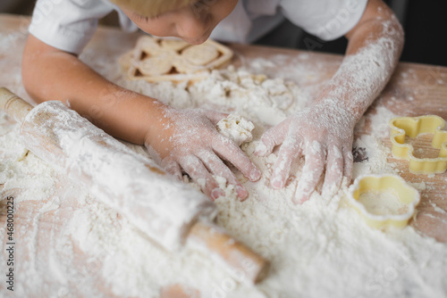 Close-up of children's hands all in flour. Cooking concept at home with kids.