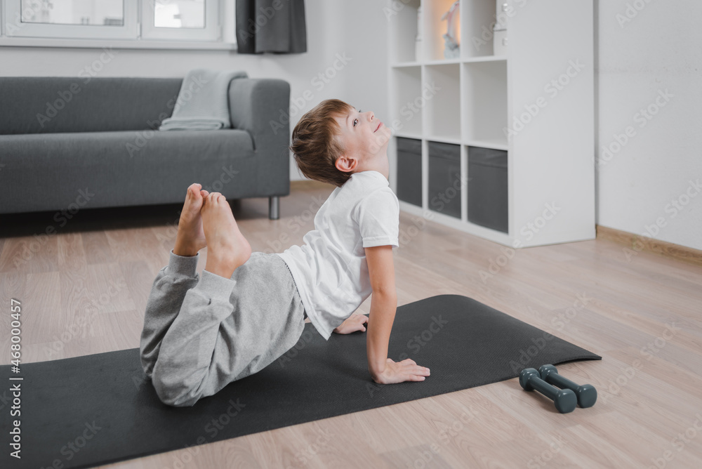 Φωτογραφία Boy-child doing fitness, yoga at home in the living room