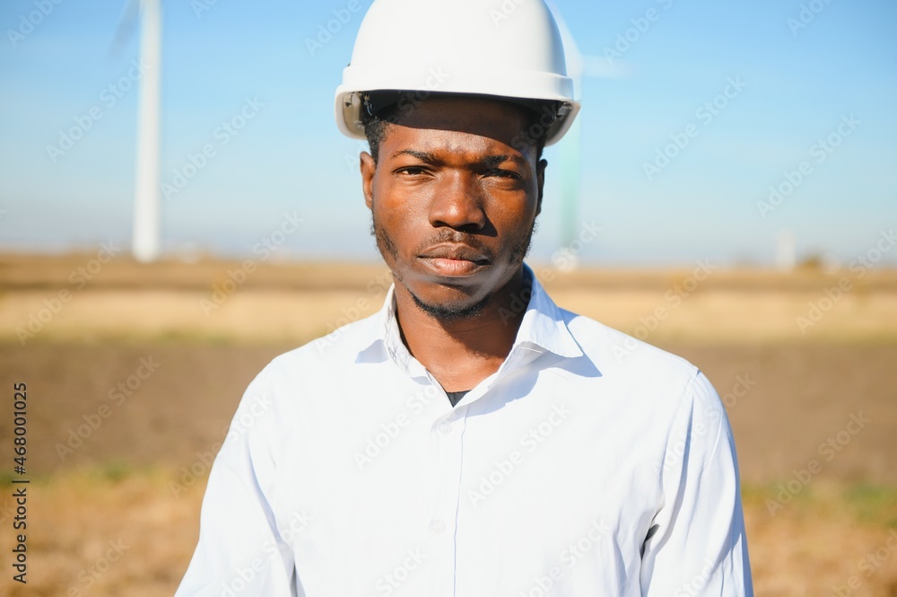 Male engineer on windmill farm for electric power production Male engineer on windmill farm for electric power production
