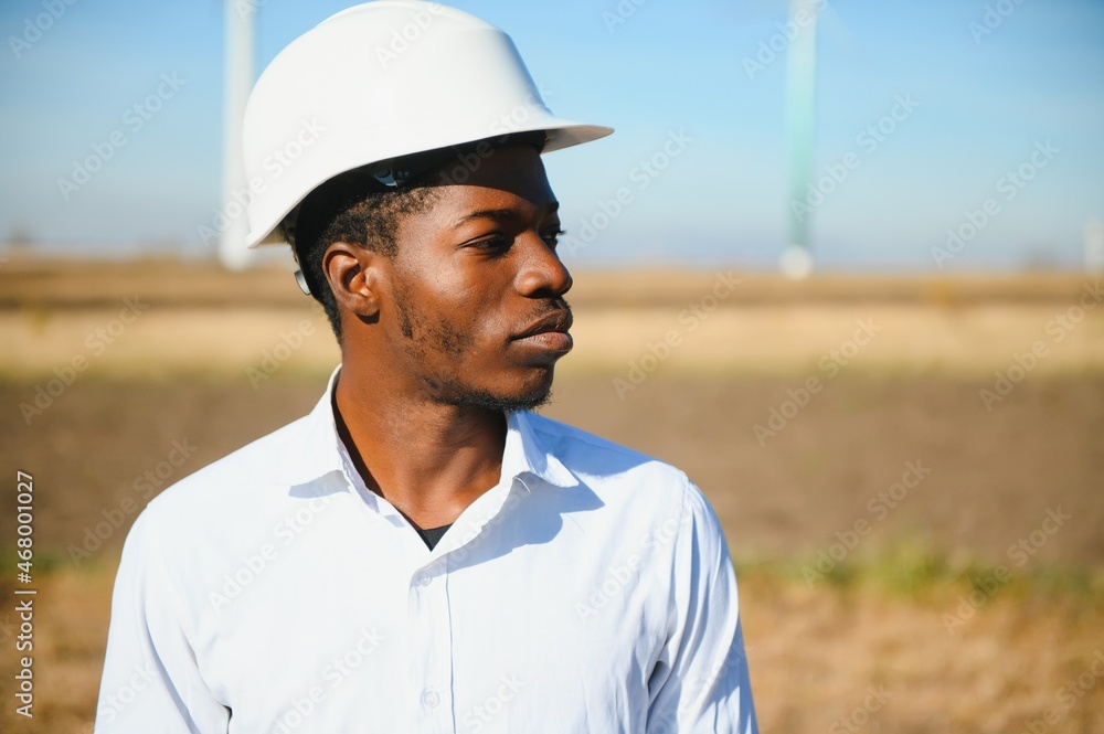 African American worker in a construction helmet African American worker in a construction helmet