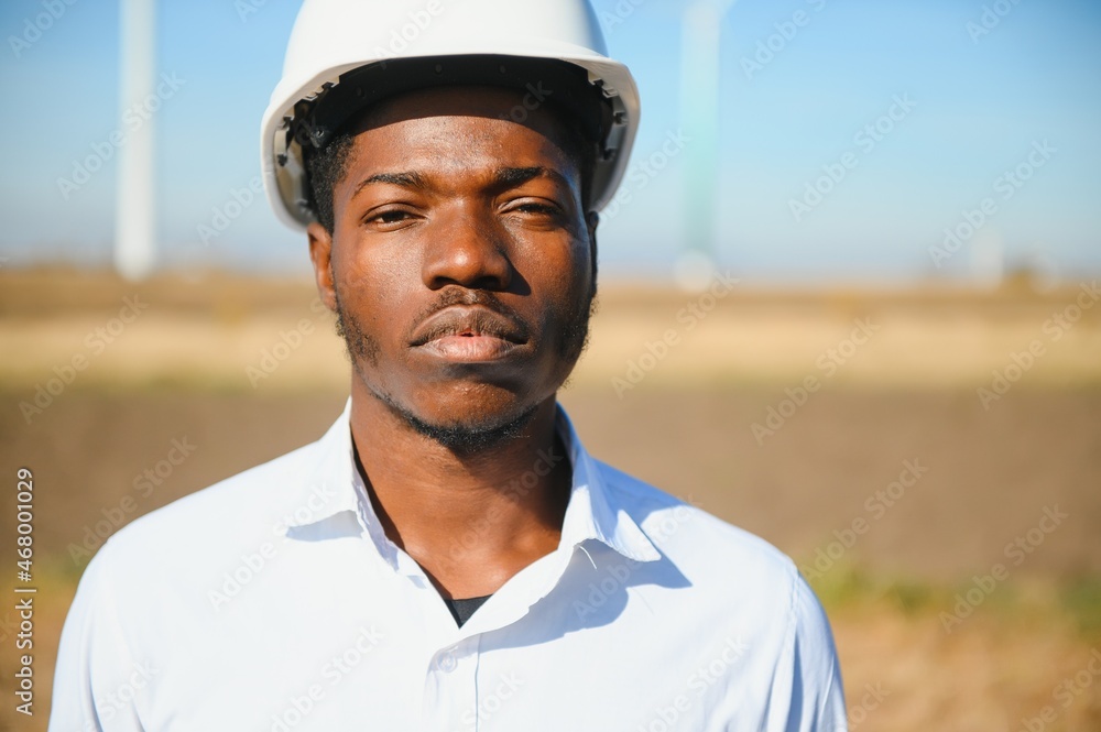 Male engineer on windmill farm for electric power production Male engineer on windmill farm for electric power production