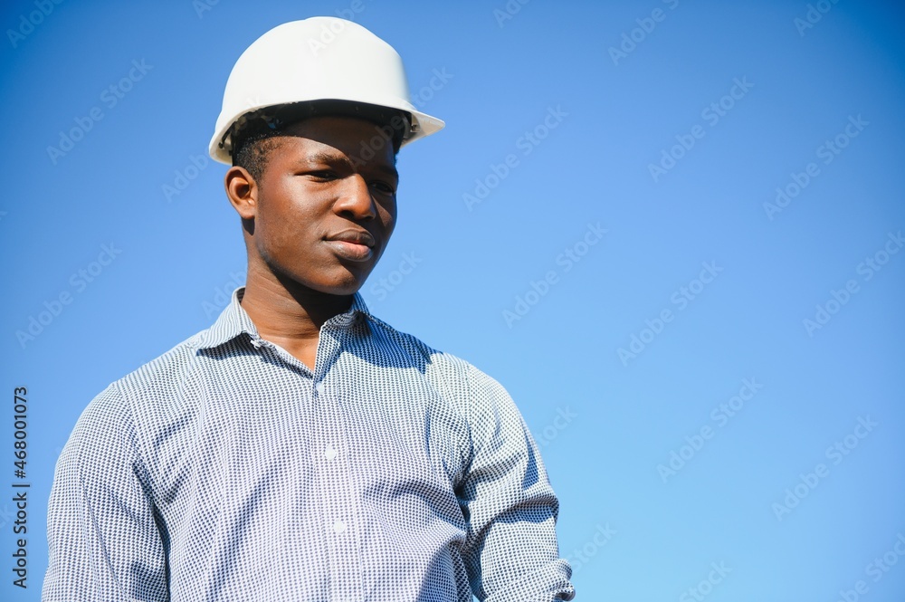 African American worker in a construction helmet African American worker in a construction helmet