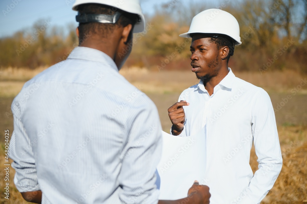 two male surveyors working at mining site two male surveyors working at mining site