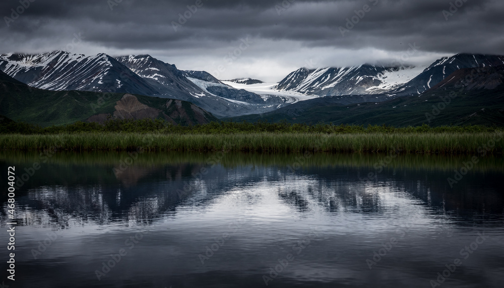 The Gulkana Glacier is reflected in a pond in the Alaska Range by the Richardson Highway, Alaska. 