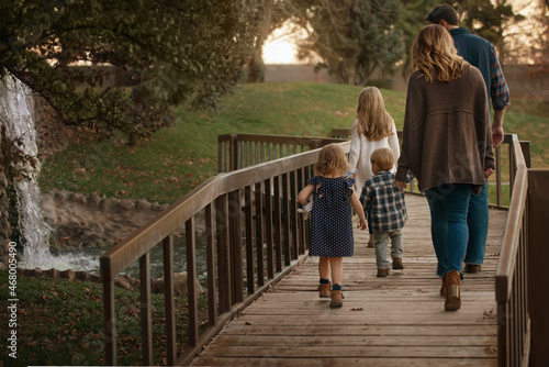 Family Waking on Wooden Bridge Together Holding Hands Fun Sweet Pretty Beautiful Background Loving 