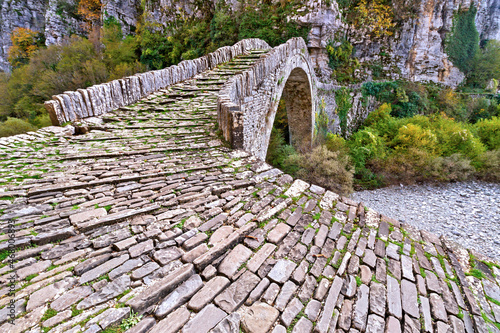 Stone bridge of Kokkoris, one of the famous and beautiful traditional stone bridges in Zagori region, northern Greece, Europe. Most of the bridges were built by local stone masons during the 1900's. 