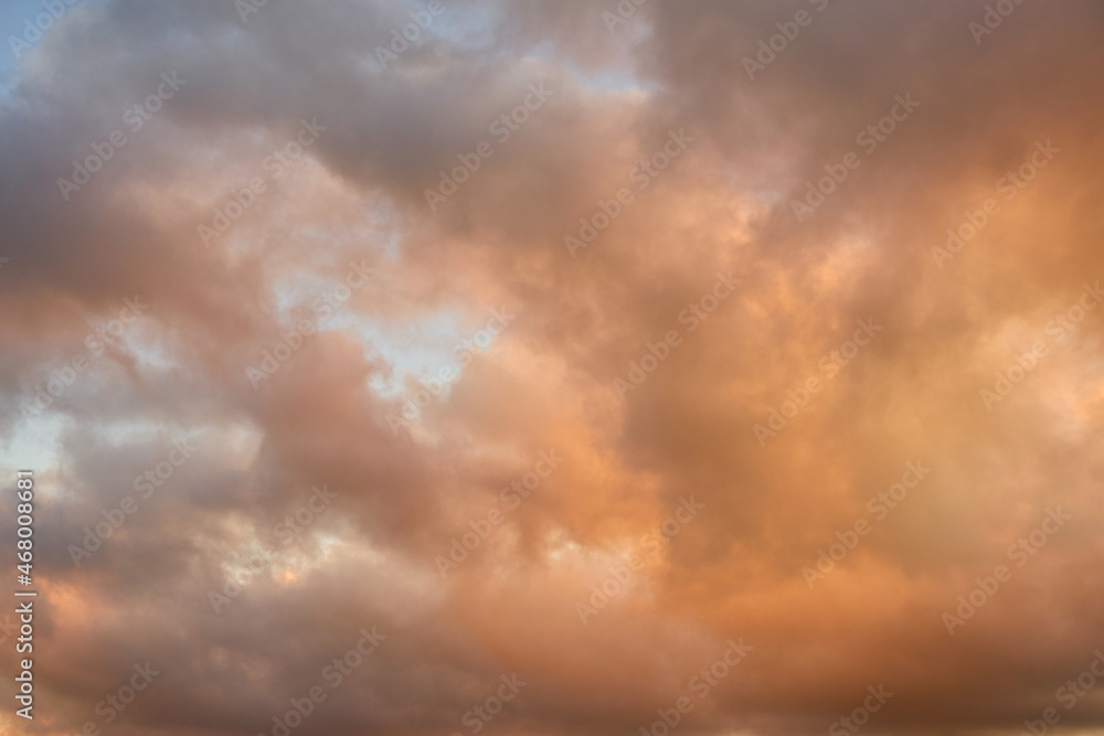 Colorful clouds in the setting sky as a background.