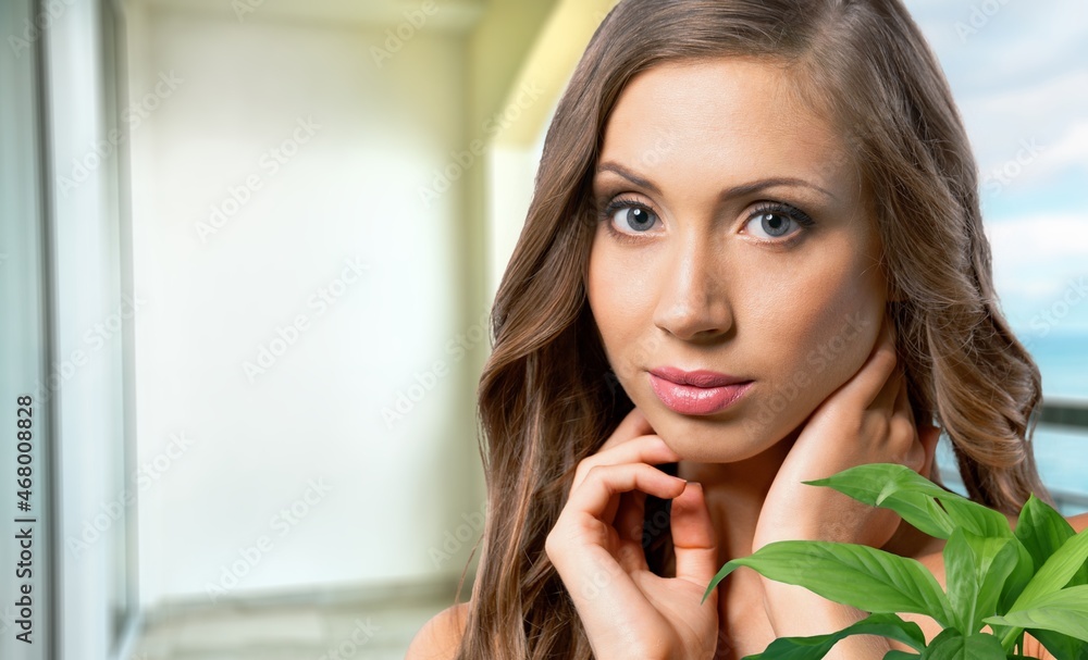 Young beautiful woman with healthy skin and palm leaves. Young beautiful woman with healthy skin and palm leaves.