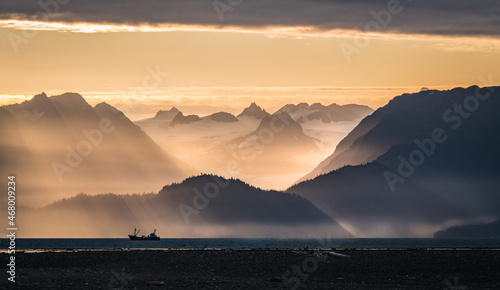 Fog burns off Kachemak Bay as seen from Homer, Alaska at sunrise. 