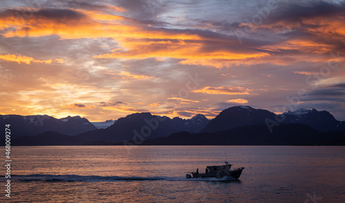 Sunrise over Kachemak Bay in Homer, Alaska with a fishing boat in the foreground. 