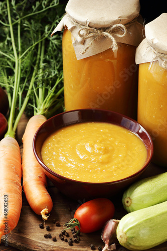 Squash caviar from zucchini, carrot, onions, spices on darkk moody rustic wooden background, closeup, homemade food in plastic free jars, sustainable living and saving leftovers concept photo