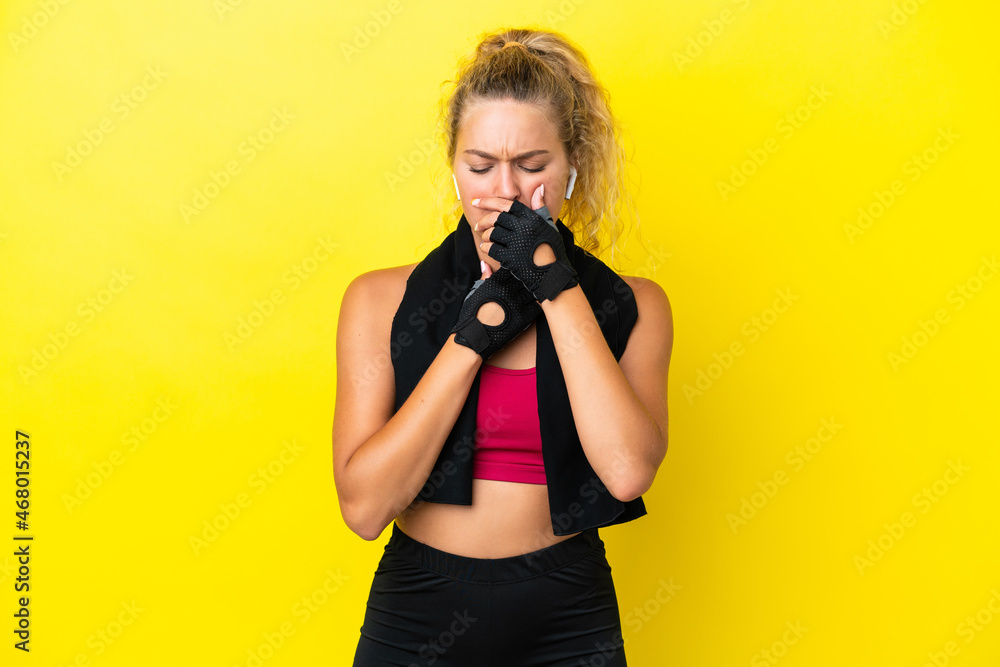 Sport woman with towel isolated on yellow background is suffering with cough and feeling bad