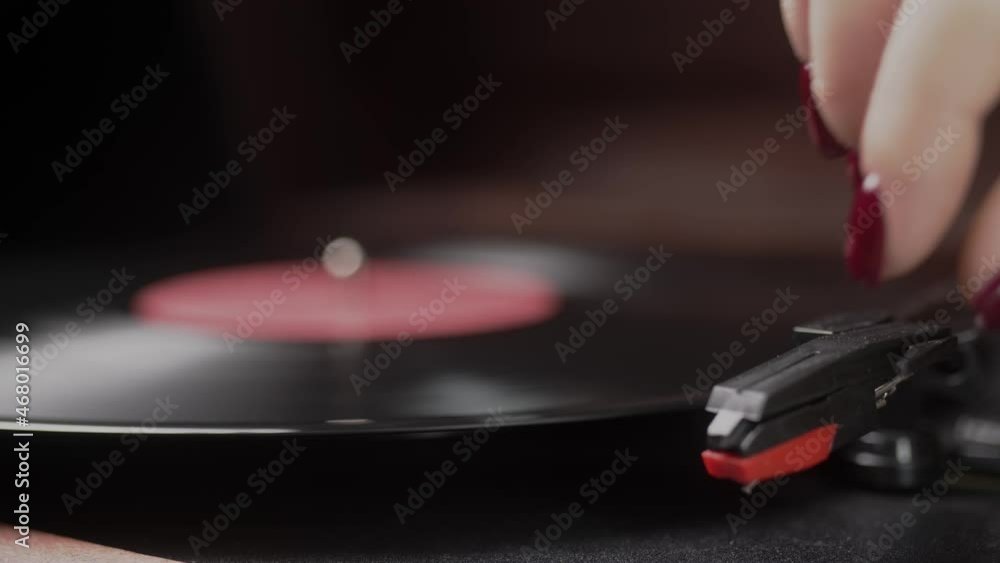 Turntable player, dropping stylus needle on vinyl record playing Turntable player, dropping stylus needle on vinyl record playing