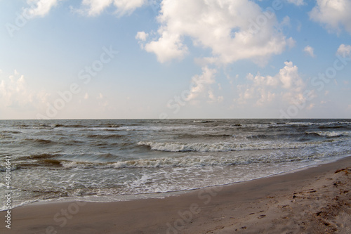 Seascape. Sea Waves rollof the sandy shore. The sky with clouds. Seashore background for a post  screensaver  wallpaper  postcard  poster  banner  cover  title for a website. High quality photography
