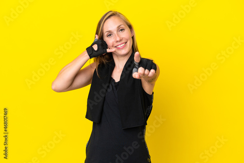 Young sport English woman isolated on white background making phone gesture and pointing front