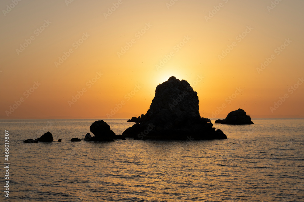 small rock island at sunrise