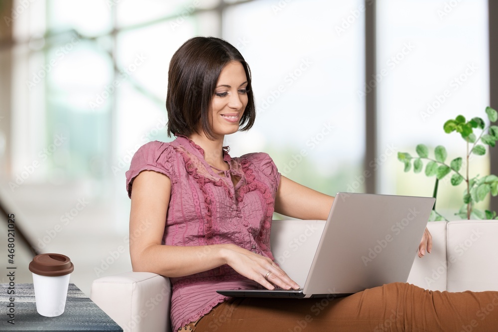Young happy smiling student using laptop in the office. Young happy smiling student using laptop in the office.