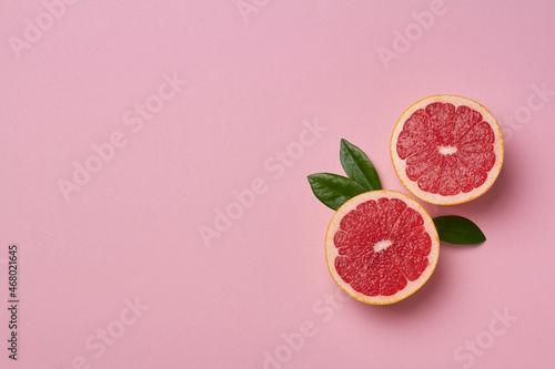 grapefruit on pink background copy space