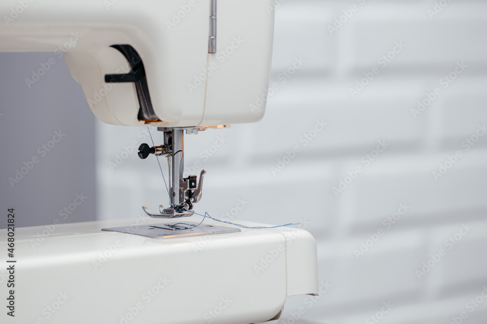 Close-up of the sewing machine and sewing needle studio. macro