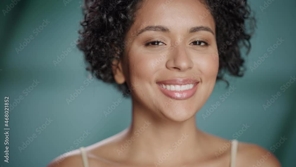 Close Up Female Beauty Portrait. Happy Multiethnic Black Latina Woman with Natural Healthy Skin, Curly Afro Hair Posing and Smiling. Wellness and Skincare Concept on Soft Isolated Background. Close Up Female Beauty Portrait. Happy Multiethnic Black Latina Woman with Natural Healthy Skin, Curly Afro Hair Posing and Smiling. Wellness and Skincare Concept on Soft Isolated Background.
