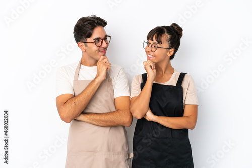 Restaurant mixed race waiters isolated on white background looking looking at each other