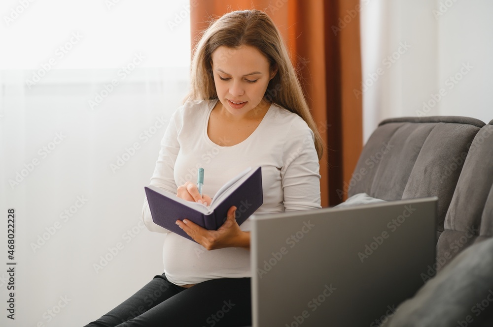 Pregnant woman video chatting with doctor on laptop. Professional medical online consultation concept. Pregnant woman video chatting with doctor on laptop. Professional medical online consultation concept.