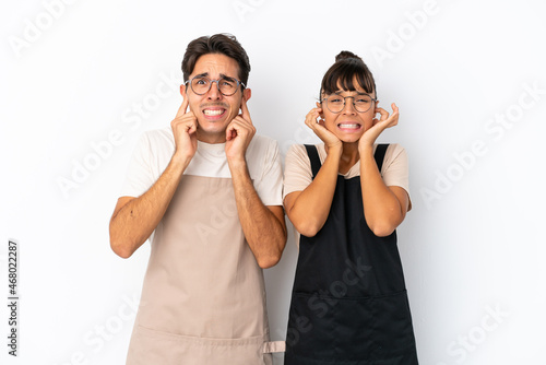 Restaurant mixed race waiters isolated on white background covering both ears with hands