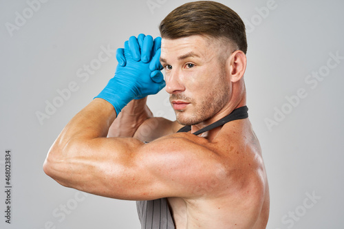 pumped up man in apron wearing rubber gloves posing cleaner