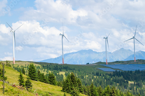 green energy, solar panels and wind power station on mountain