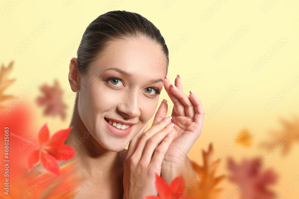 Beautiful young woman with autumn leaves on light background Beautiful young woman with autumn leaves on light background