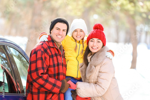 Happy family near car in fo...