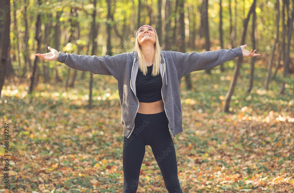  happy woman in autumn with outstretched arms