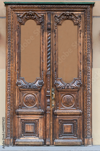 wooden door with a beautiful decorative wooden finish in the historical part of the Russian city of St. Petersburg